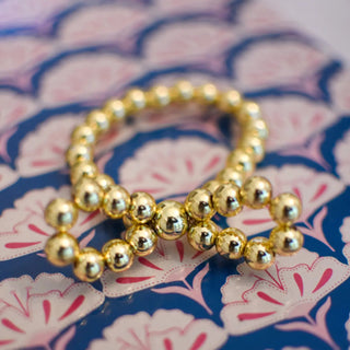 gold beaded stretch bracelet with gold bow