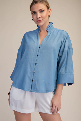 Sky Blue Ruffle Top – chambray blue button-front top, ruffle stand collar, 3/4 sleeves
