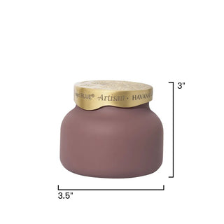 a taupe velvet-finish jar with a gold lid candle