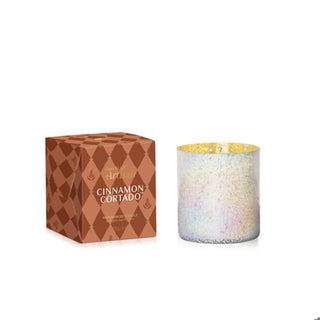 an iridescent tumbler in a copper gift box candle