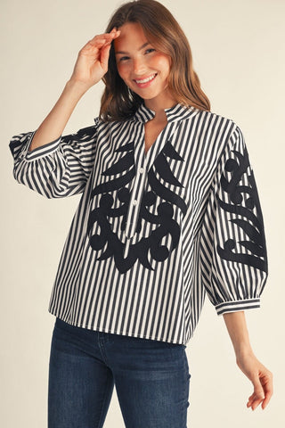 Lottie Black Stripe Top – black and white stripe split-neck top with bold black appliqué and puff sleeves
