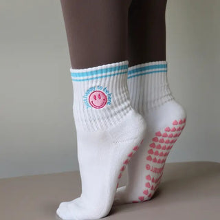 white grip socks with smiley face and pink grips