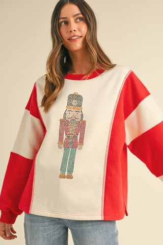 Savannah nutcracker Embellished Sweatshirt – red and cream colorblock sweatshirt with sequin nutcracker graphic