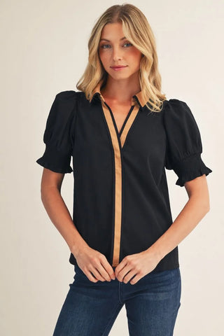 The Sutton Top – black blouse with tan contrast placket and collar trim, puff short sleeves