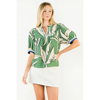 The Sloane Top – green and white palm leaf print top, split neck, puff short sleeves with blue cuffs