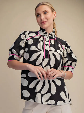 The Ellison Top – black and cream bold floral print blouse, tie mock neck with pink piping, puff short sleeves