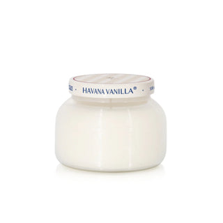a white jar with a silver lid candle