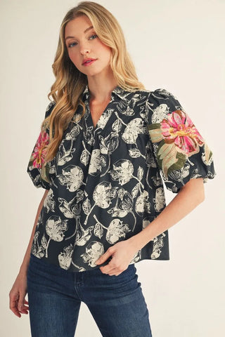 The Presleigh Top – black and cream floral print blouse with colorful embroidered sleeve, split neck, puff short sleeves