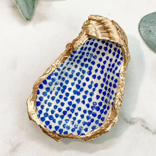 oyster shell trinket dish with blue dots and gold edge