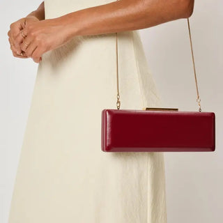 Angie Clutch – structured wine clutch with a gold chain strap