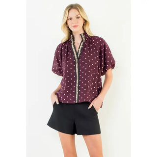 Trudy Burgundy Polka Dot Top – burgundy dot print blouse with embroidered trim placket, mock neck, short sleeves