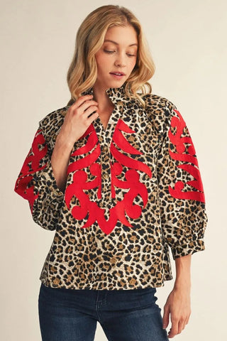 Aubrey Sue Red Applique Leopard Top – leopard print split-neck top with bold red appliqué and puff sleeves