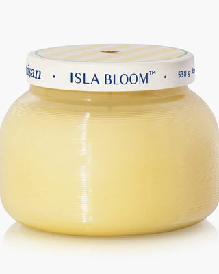 a buttery yellow jar with a silver lid candle