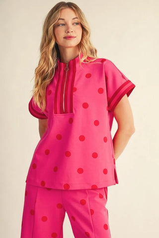 The Ruby Hot Pink Polka Dot Top – hot pink polka dot top, quarter zip mock neck, short sleeves with red cuffs