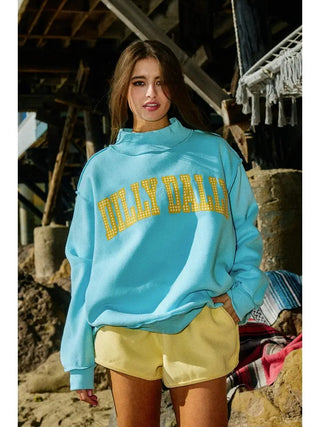 Dilly Dally Reversible Sweatshirt – aqua crew neck sweatshirt with "Dilly Dally" in yellow lettering